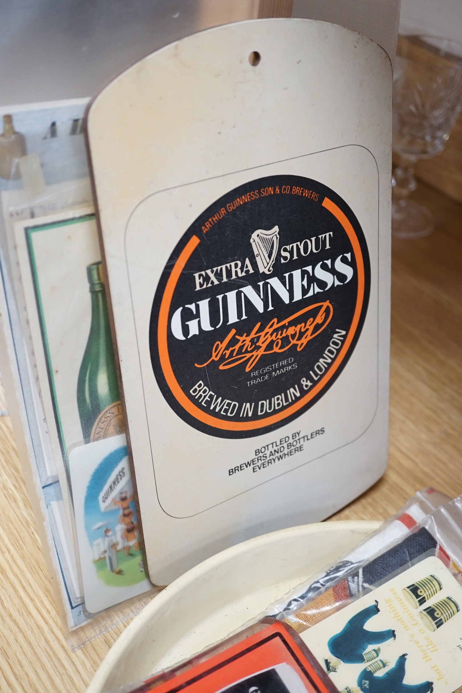 A large quantity Guinness advertising material, including a table lamp with Guinness shade, signage, bar mats, camera etc